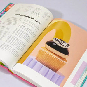The Crumbs & Doilies Recipe Book open to a Miso Caramel Cupcakes recipe with full-color photo.